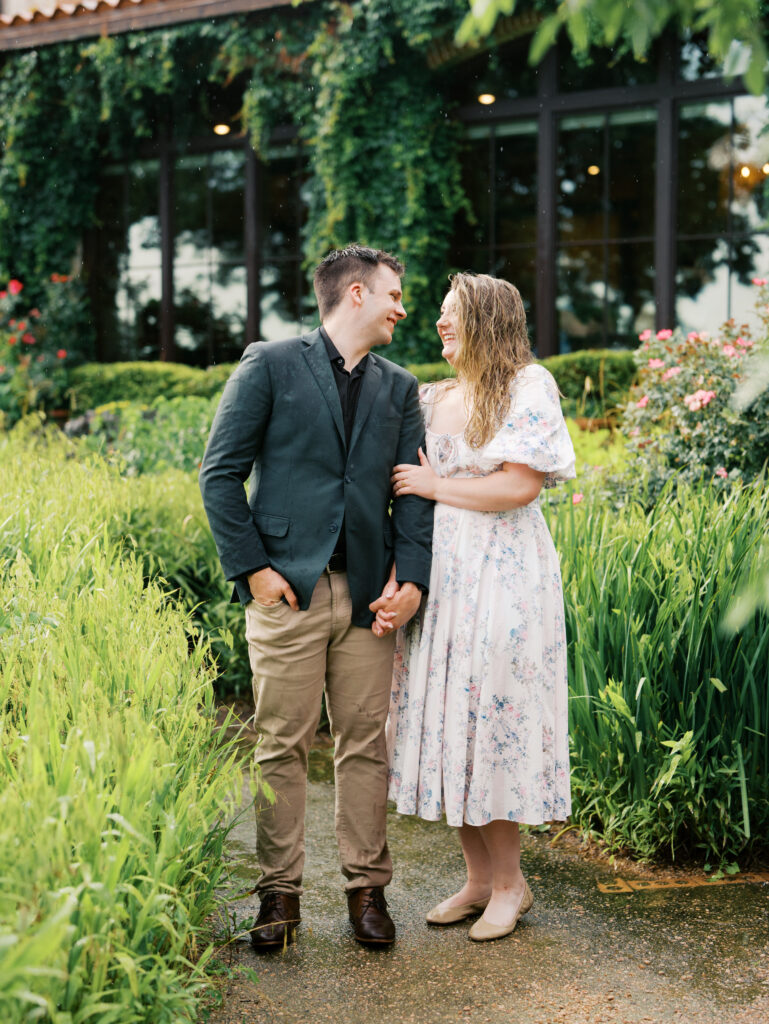 couple celebrating surprise proposal in the rain