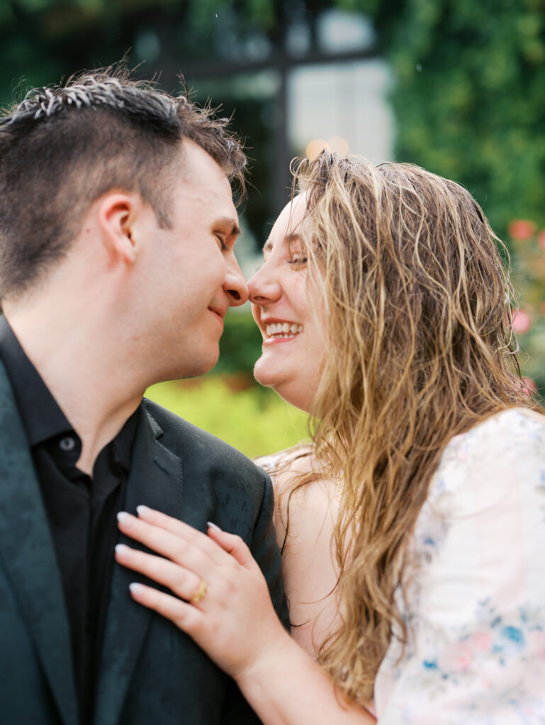couple celebrating surprise proposal in the rain