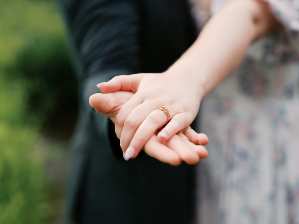 couple celebrating surprise proposal in the rain