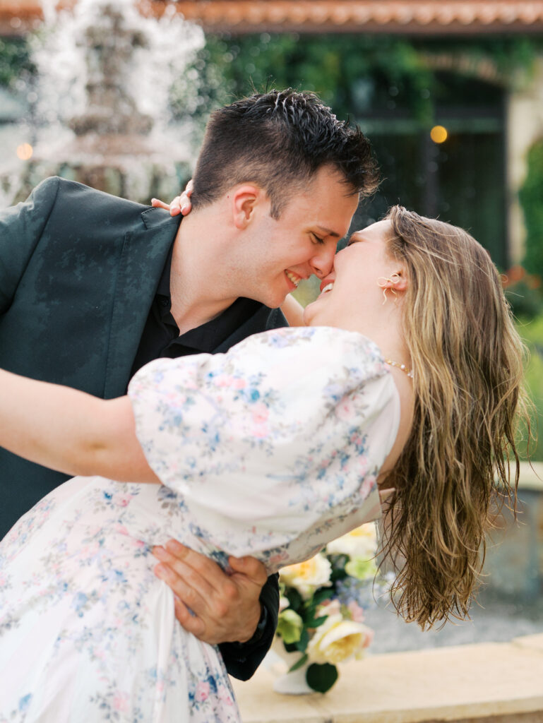 couple celebrating surprise proposal in the rain
