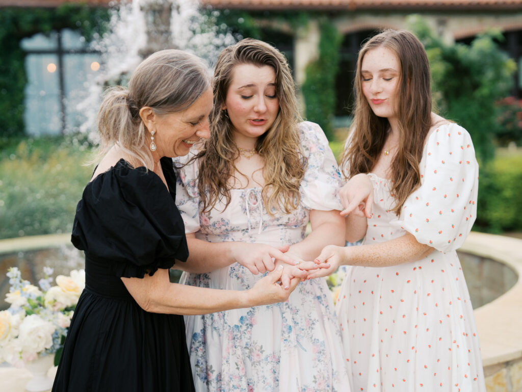 showing off engagement ring to mom and sister