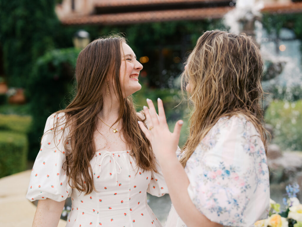 sisters smiling after surprise engagement