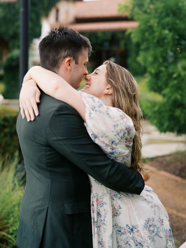 couple hugging after surprise proposal in the rain