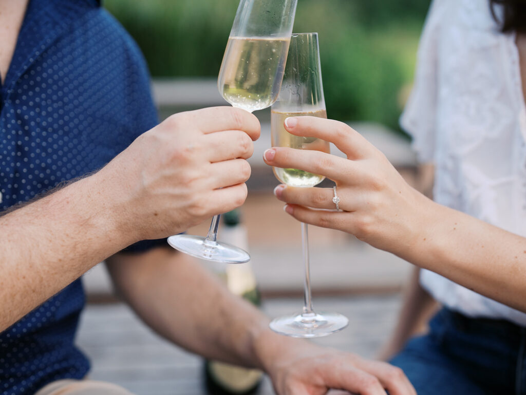 couple drinking champagne and toasting to their engagement