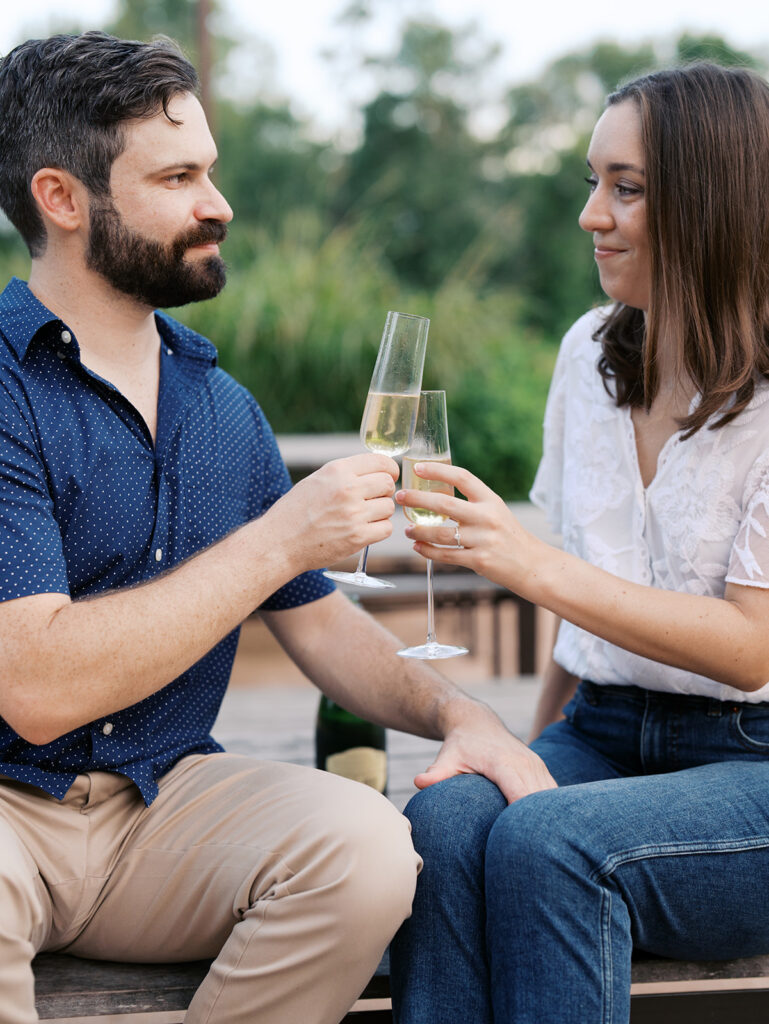 couple drinking champagne and toasting to their engagement