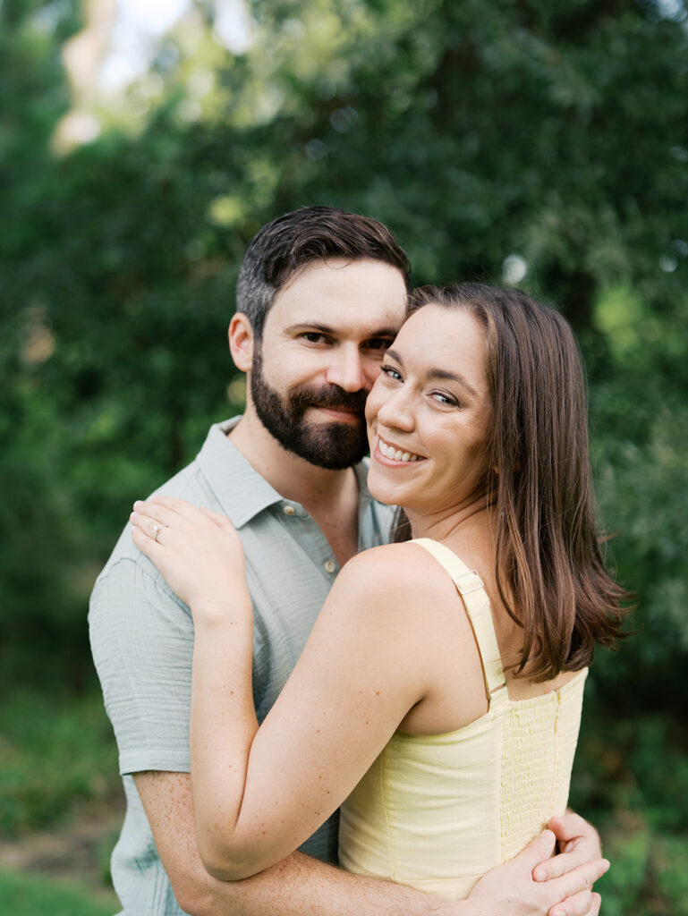 couple smiling at camera at the park