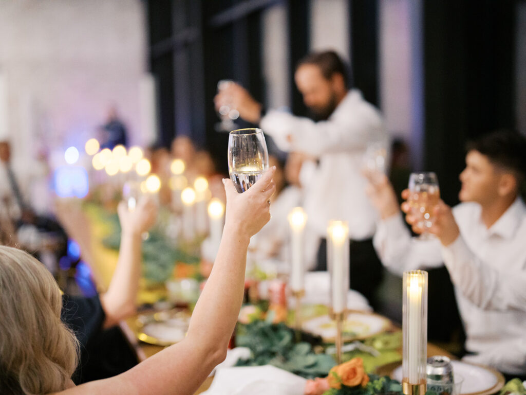 wedding guest raising a toast to bride and groom