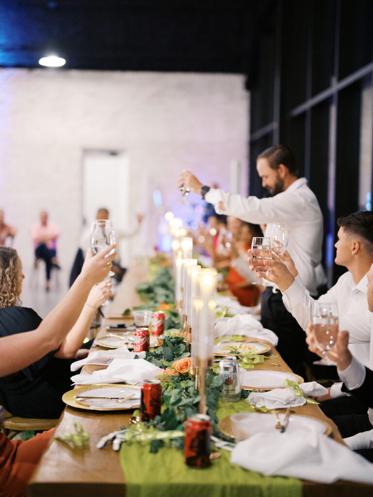 wedding guest raising a toast to bride and groom