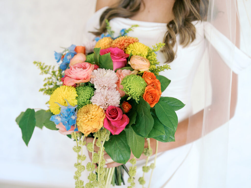 bride holding colorful bridal bouquet