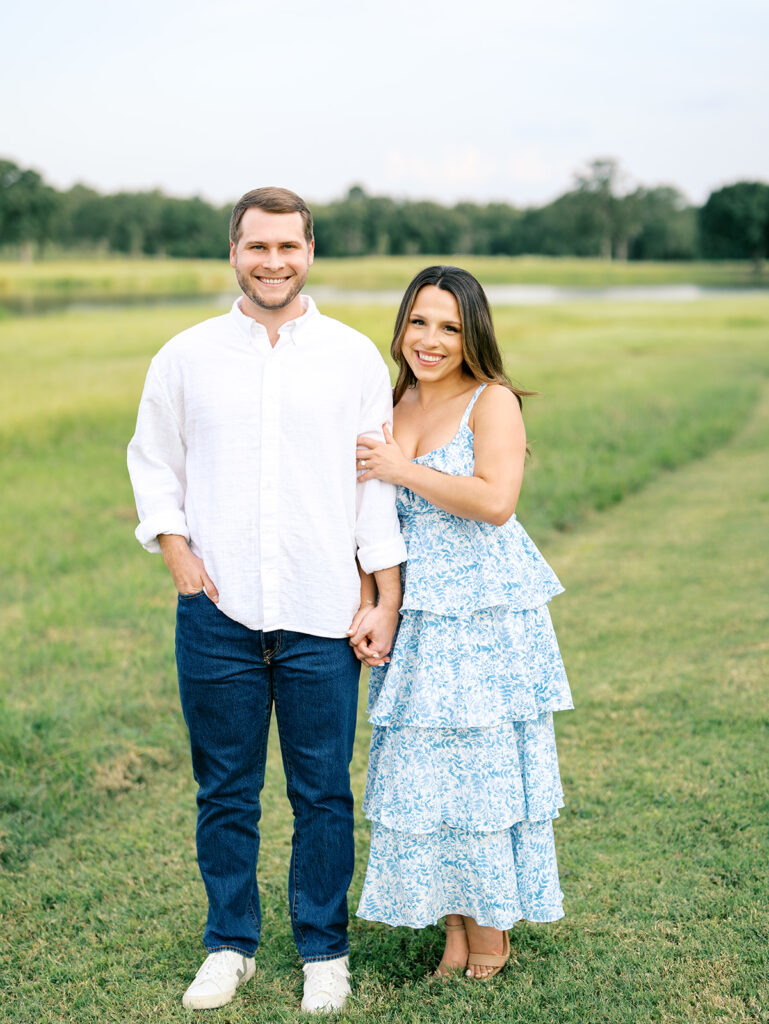 couple smiling at the camera for houston engagement pictures