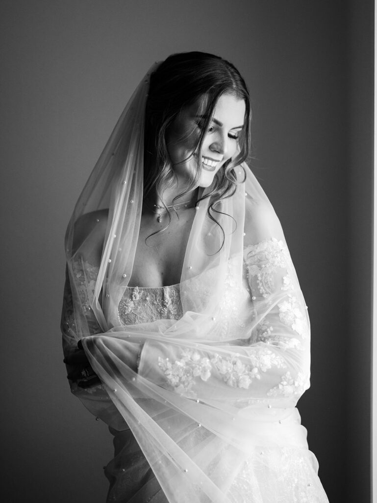 bride smiling with veil and bouquet
