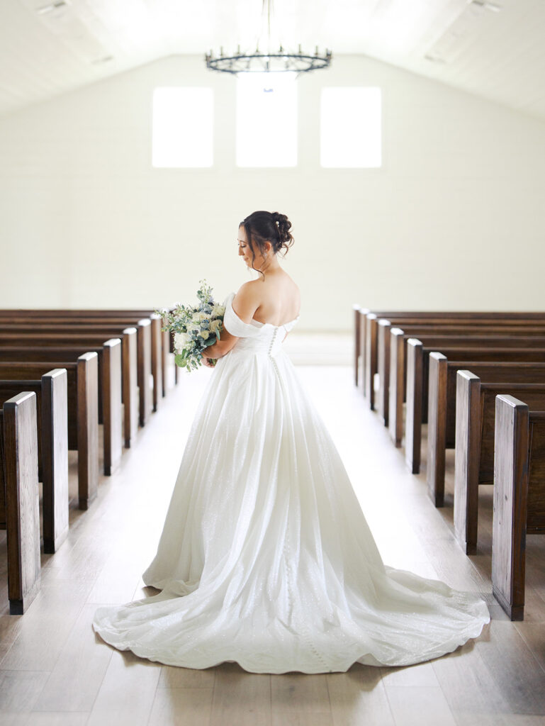 bride standing in the aisle with her bouquet
