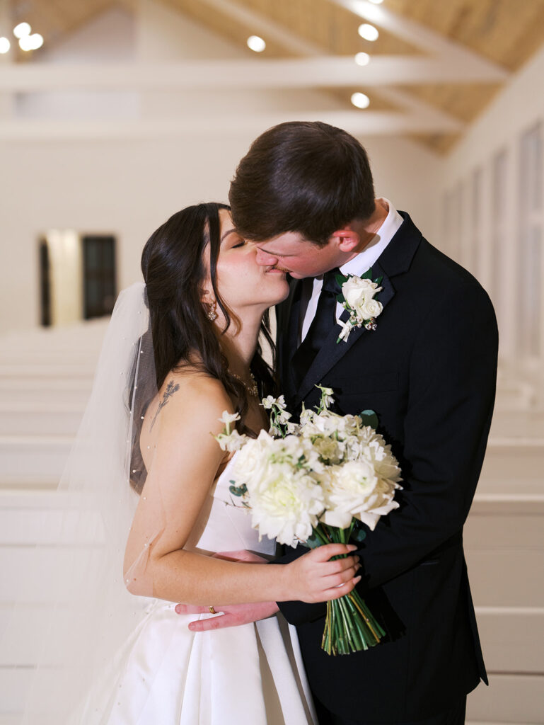 bride and groom poses indoor wedding venue in houston