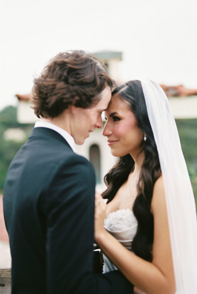 film photo of bride and groom touching foreheads