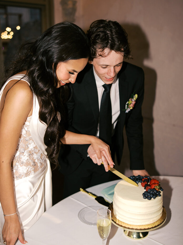 bride and groom cutting the cake vintage wedding cake photos at Villa Antonia Austin