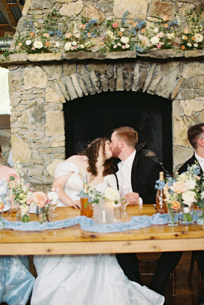 bride and groom kissing on wedding day captured through wedding photography on film