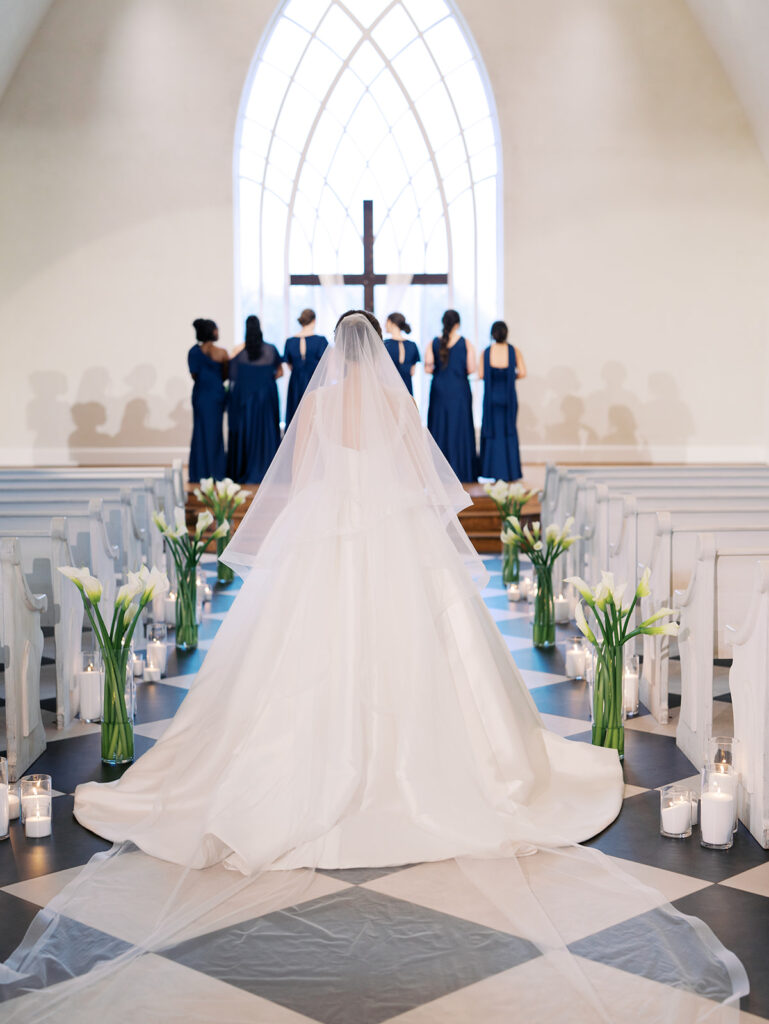 bride walking toward bridesmaids down the aisle at the weinberg at wixon valley