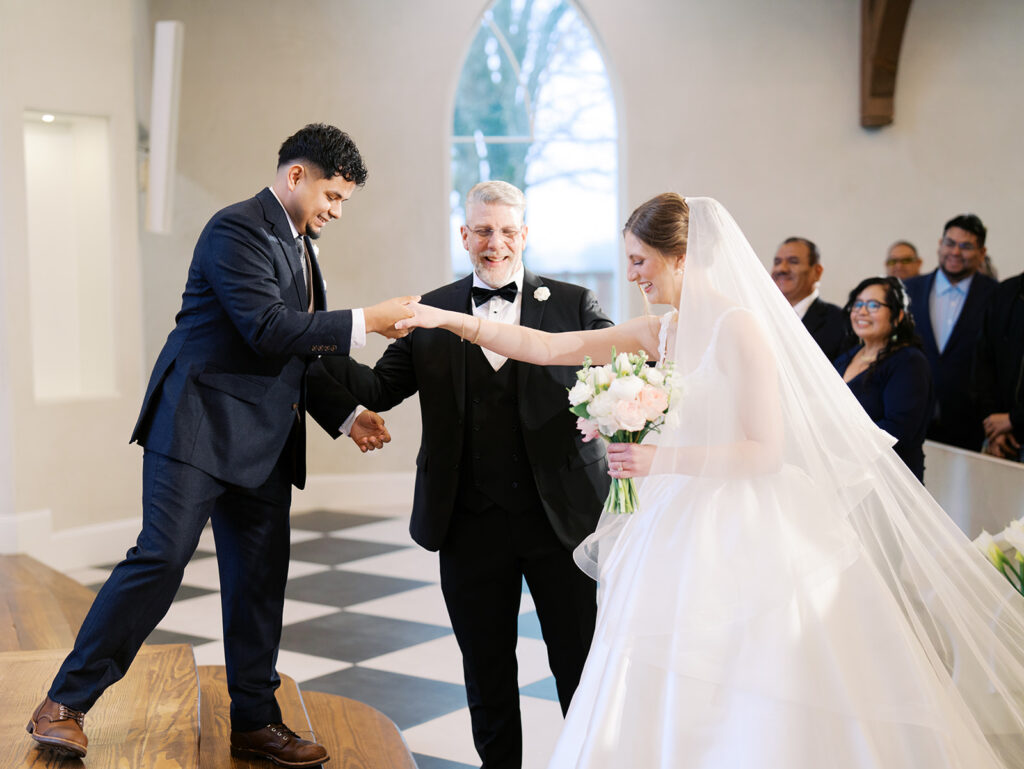 groom helping bride step onto the altar at the weinberg at wixon valley