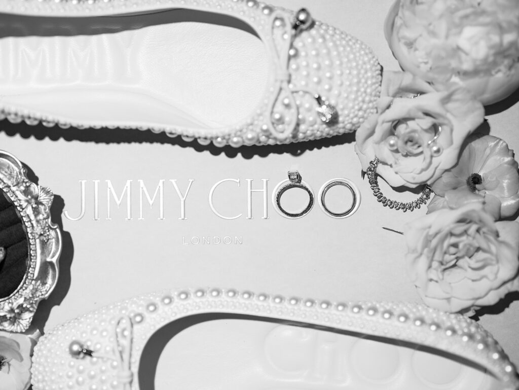 elegant timeless wedding details flatlay photography with rings flowers and shoes