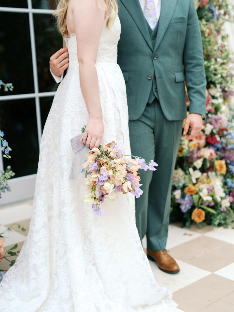 detail of bride and groom with florals