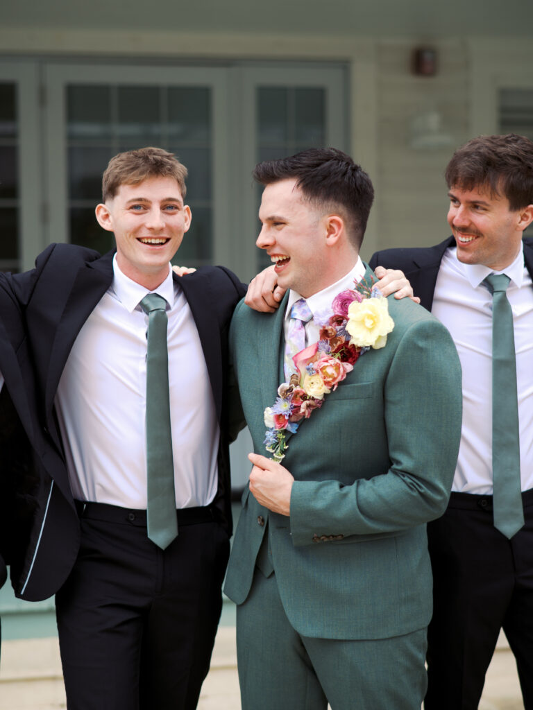groom and groomsmen smiling on wedding day