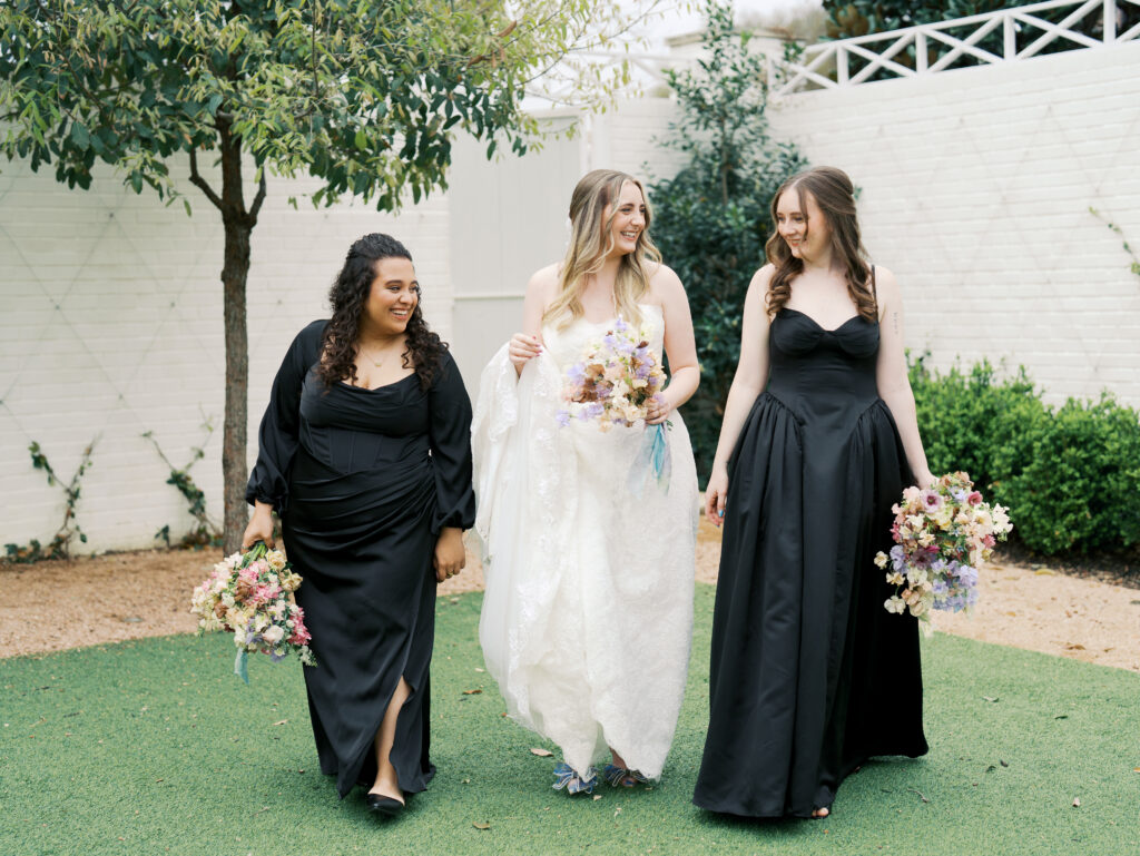bride and bridesmaids smiling on wedding day