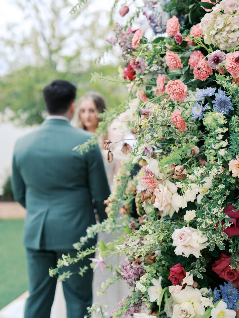 detail of bride and groom with florals