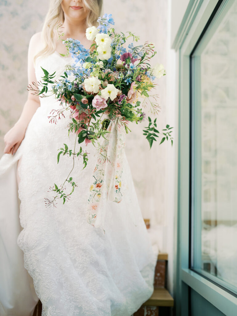 austin wedding florist makes her own bridal bouquet with spring wedding colors and flowers