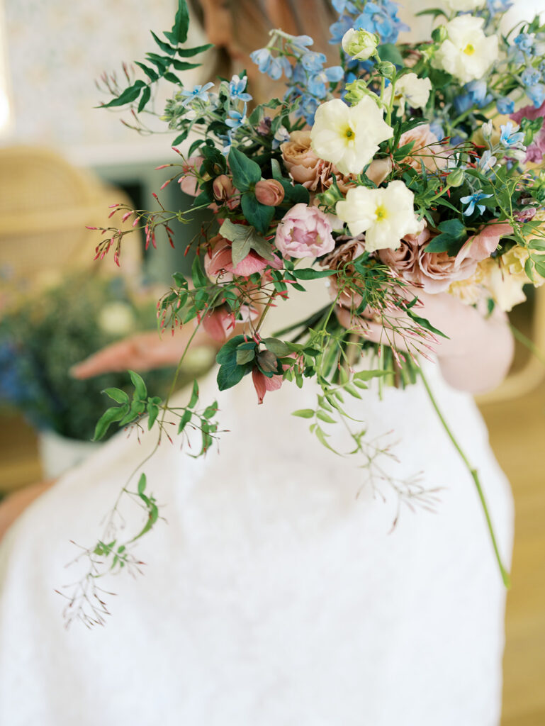 austin wedding florist makes her own bridal bouquet with spring wedding colors and flowers