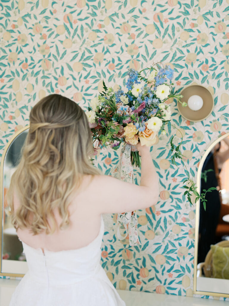 austin wedding florist makes her own bridal bouquet with spring wedding colors and flowers