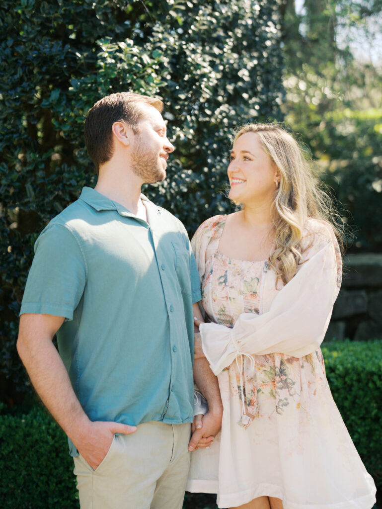 couple holding hands in garden for spring engagement session