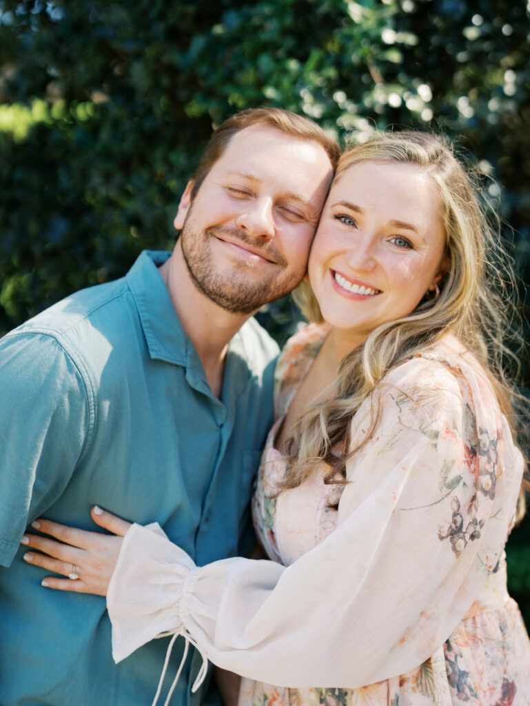 man and woman smiling in Texas garden for engagement session Dreamy Outdoor Engagement Photos in Botanical Gardens