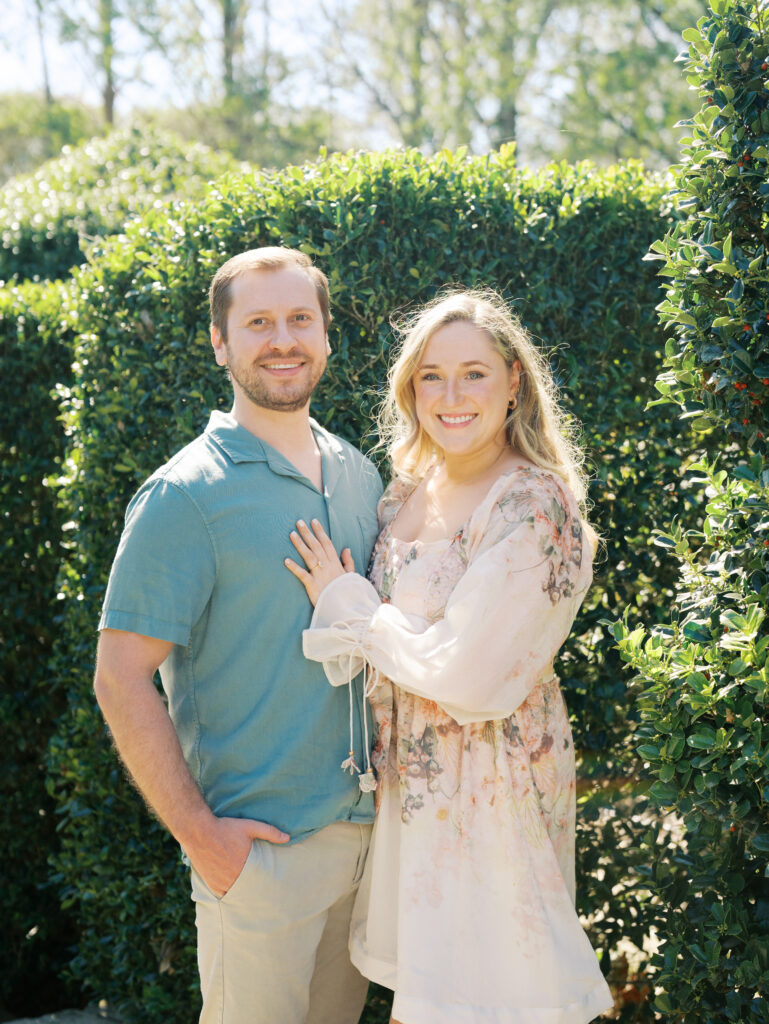 couple holding each other in garden for spring engagement session