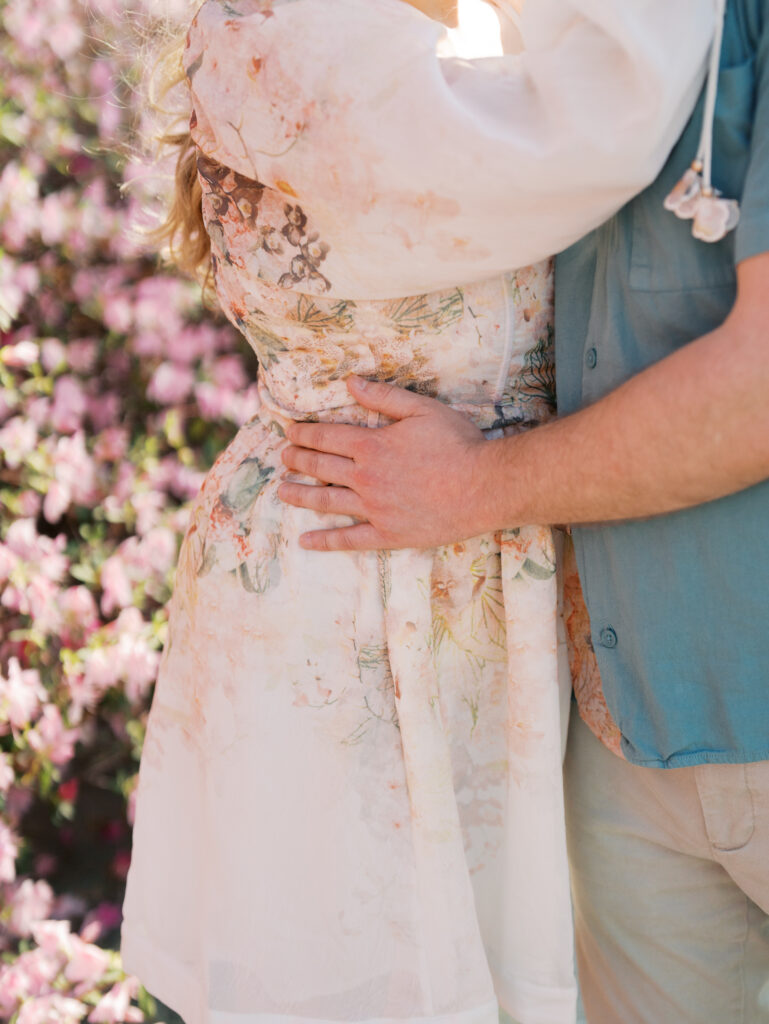 texas garden engagement session man and woman hugging Dreamy Outdoor Engagement Photos in Botanical Gardens
