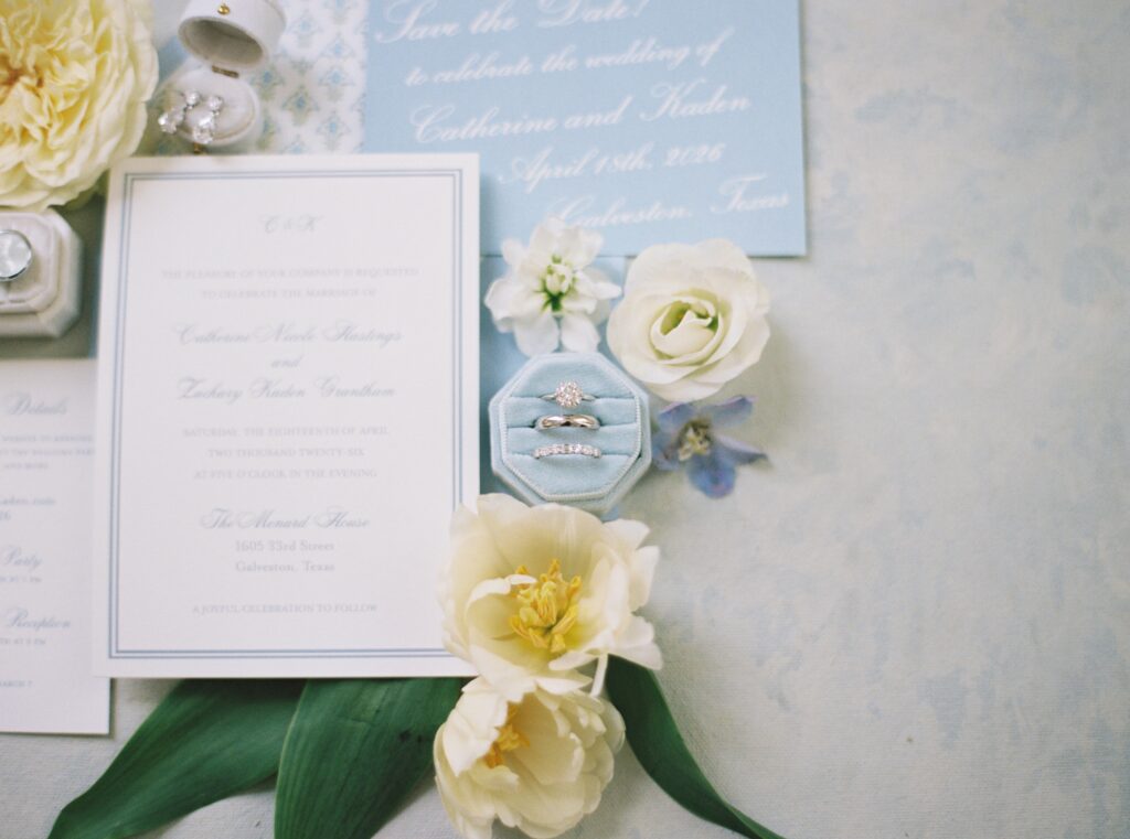rings and wedding invitation suite with florals 
