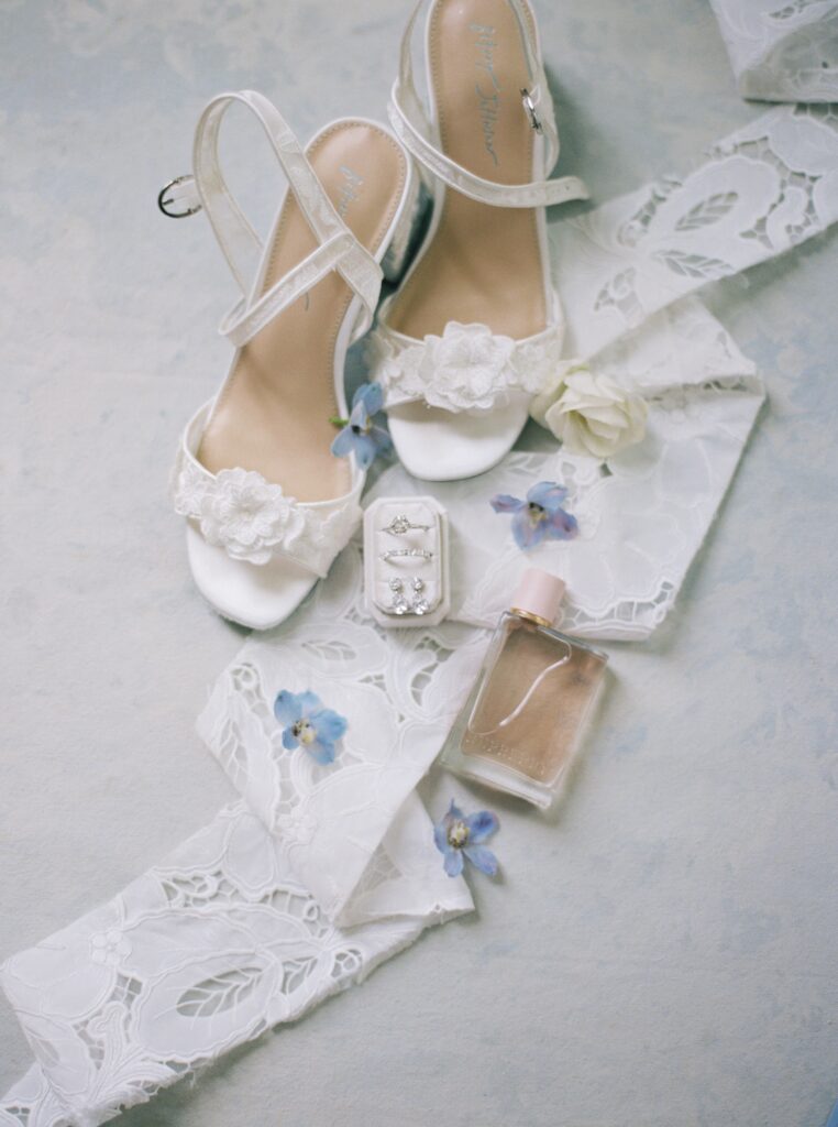 wedding details and brides shoes showing blue and white color scheme 