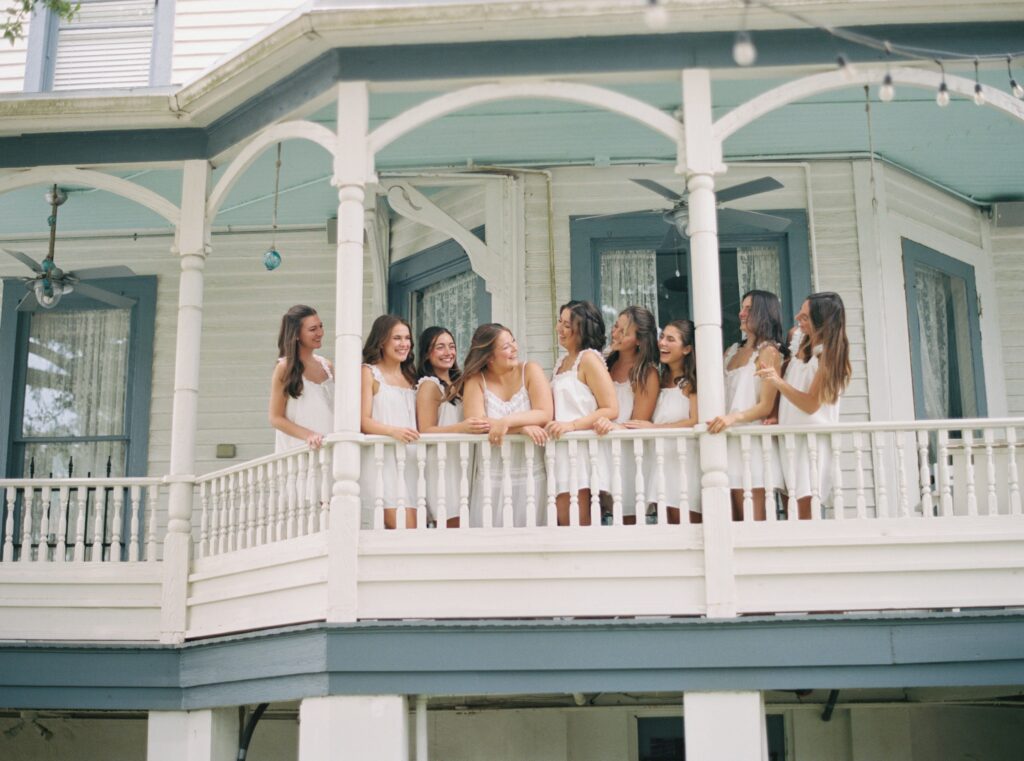 bridal party laughing and smiling on patio 