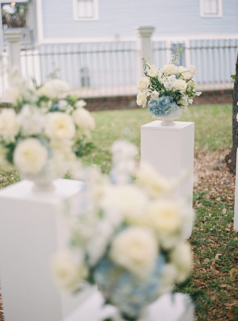 blue and white florals on pillars on wedding day in galveston 