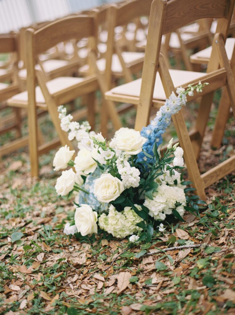 blue and white florals with touches of green at ceremony space 