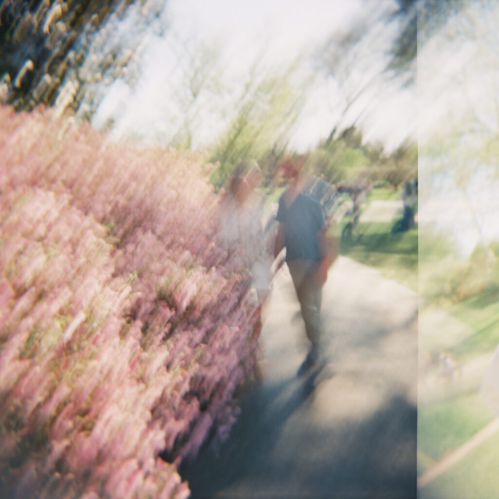 double exposure blurry photo of couple walking in gardens