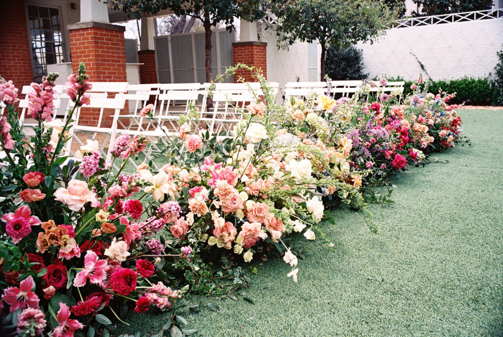 film wedding photography of wedding aisle flowers for a spring garden wedding in austin