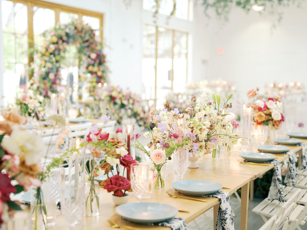 wedding reception tablescape with flowers candles and vintage glasses