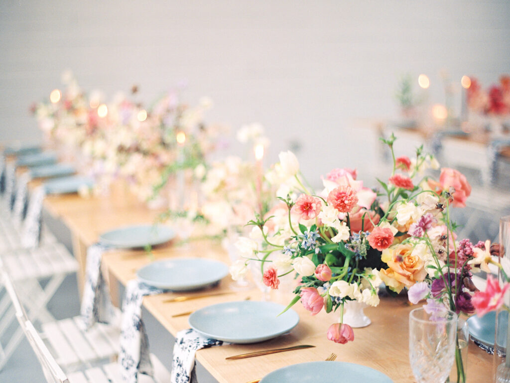 wedding reception tablescape with flowers candles and vintage glasses