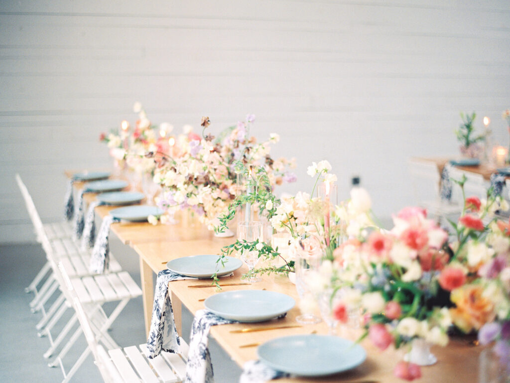 wedding reception tablescape with flowers candles and vintage glasses