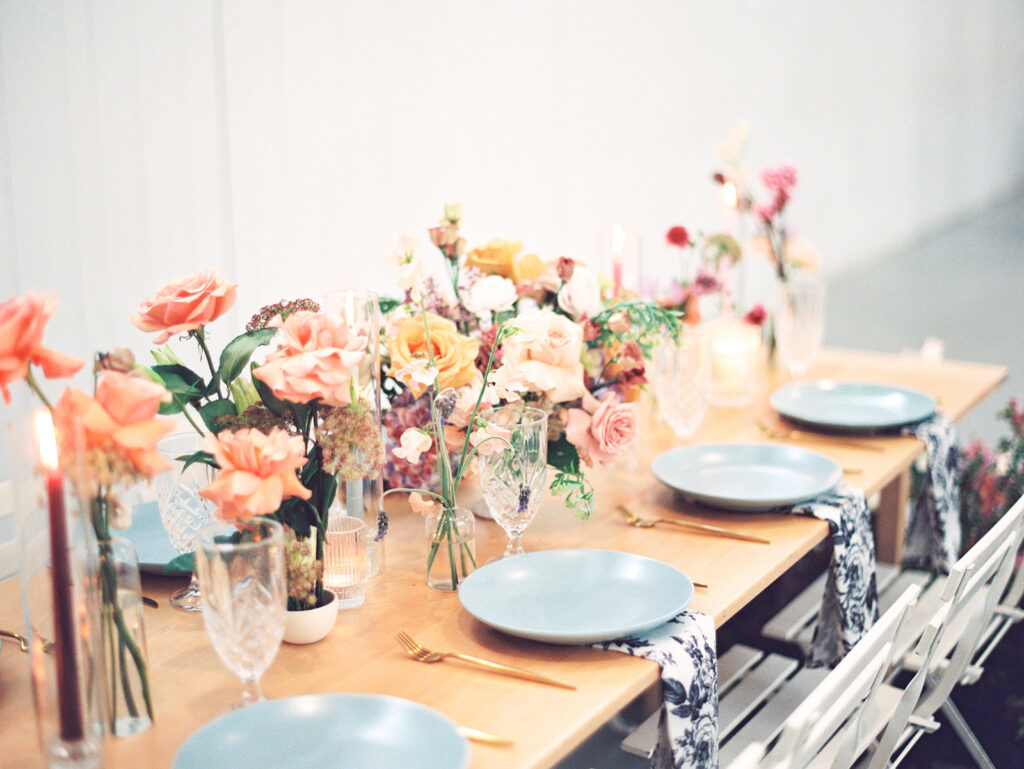 wedding reception tablescape with flowers candles and vintage glasses