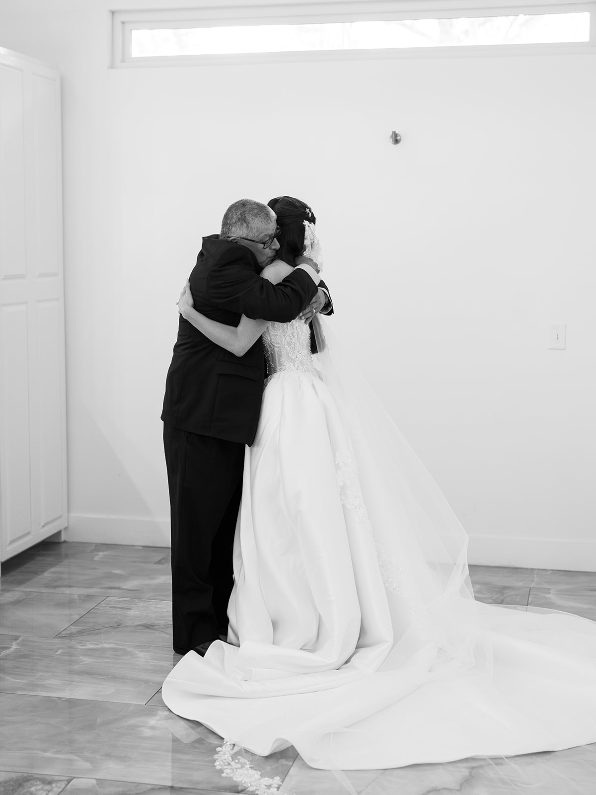 bride and father having a first look on their wedding day 