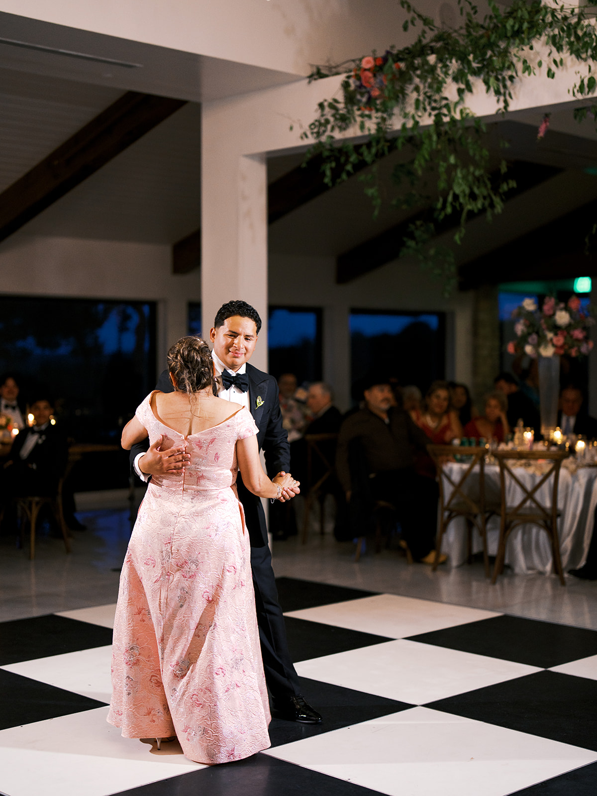 a groom dancing with his mother n his wedding day